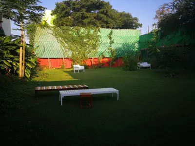 two benches in a yard with a fence at Barefeet Naturist Resort in Bangkok