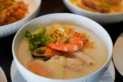 a bowl of soup with shrimp and other food at Marriott Executive Apartments Bangkok, Sukhumvit 101 in Bangkok