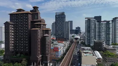 a city skyline with tall buildings and train tracks at Marriott Executive Apartments Bangkok, Sukhumvit 101 in Bangkok