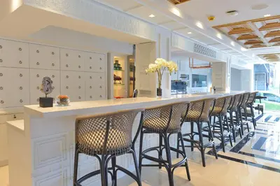a row of chairs lined up at a bar in a store at Riva Arun Bangkok in Bangkok
