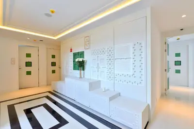 a room with a wall with a display of musical instruments at Riva Arun Bangkok in Bangkok
