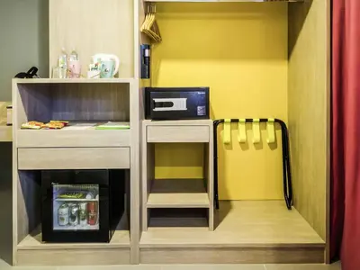 a small kitchen with a counter and a microwave at Ibis Styles Bangkok Sukhumvit 50 in Bangkok
