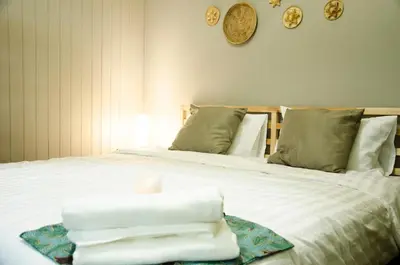 a bedroom with a bed with towels on it at GOODFELLAS THONG LO HOSTEL #No check in after 5pm - Check in time needed# in Bangkok