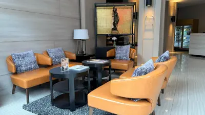 a lobby with couches and chairs and a table at Civic Horizon Hotel & Residence in Bangkok