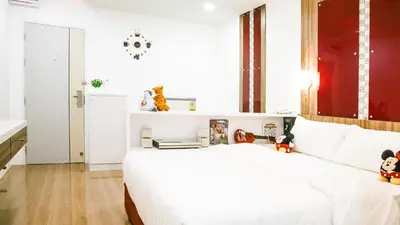 a bedroom with a white bed with stuffed animals on it at Sunset Residence Pinklao in Bangkok