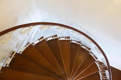 a spiral stair case with a spiral staircase at Baan Sawasdee Residence in Bangkok