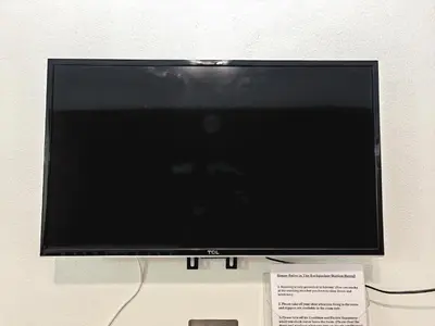 a flat screen tv sitting on top of a table at The Backpacker stn in Nonthaburi