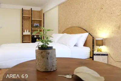 a hotel room with a bed and a table at Area 69 (Don Muang Airport) in Bangkok
