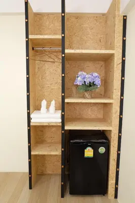 a closet with a black refrigerator and a sink at Area 69 (Don Muang Airport) in Bangkok