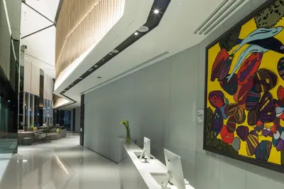 a large colorful painting on the wall in a hallway at Modena by Fraser Bangkok in Bangkok