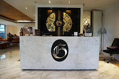 a store counter with a gold and black sign on it at Aspira G Sukhumvit 33 in Bangkok