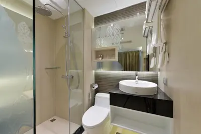 a bathroom with a toilet and a sink and a shower at Aspira G Sukhumvit 33 in Bangkok