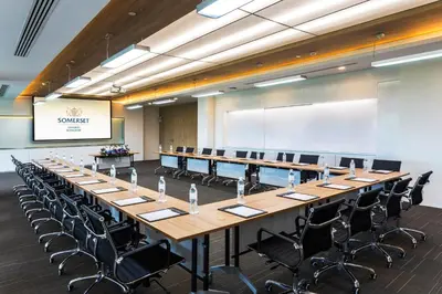 a large conference room with a long table and chairs at Somerset Ekamai Bangkok in Bangkok