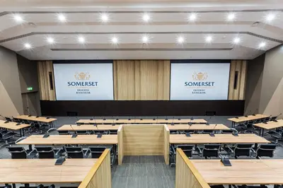 a large lecture hall with desks and screens at Somerset Ekamai Bangkok in Bangkok
