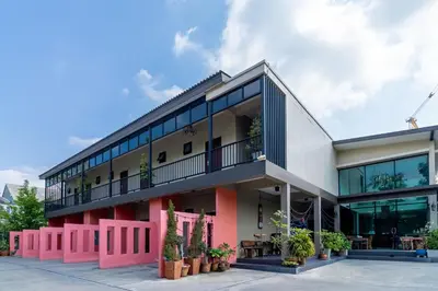an apartment building with a balcony and plants at The Pool Resort in Bangkok