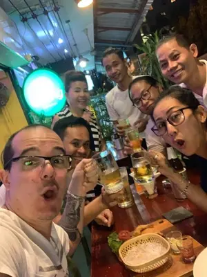 a group of people sitting around a table with drinks at Maderla in Bangkok