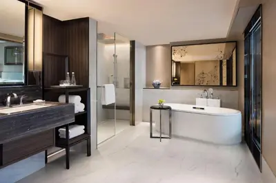 a bathroom with a tub and a sink at Bangkok Marriott Marquis Queens Park in Bangkok
