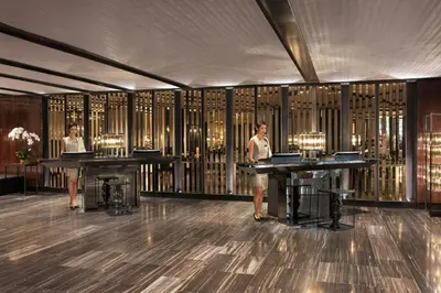 two women standing in a room with two tables at Bangkok Marriott Marquis Queens Park in Bangkok