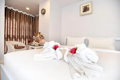 a bedroom with two swans made out of towels on a bed at Parvena Hotel Sathorn in Bangkok