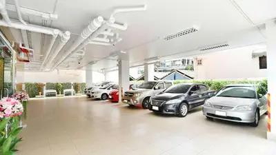 a parking lot with cars parked in it at Parvena Hotel Sathorn in Bangkok
