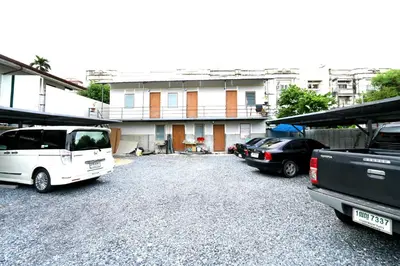 a group of vehicles parked in front of a house at T3 Residence in Bangkok