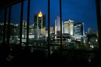 a view of a city skyline at night from a window at Arte Hotel - SHA Extra Plus in Bangkok