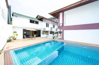 a swimming pool in the courtyard of a house at The President Hotel at Chokchai 4 in Bangkok