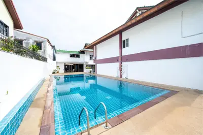 a swimming pool in the middle of a building at The President Hotel at Chokchai 4 in Bangkok