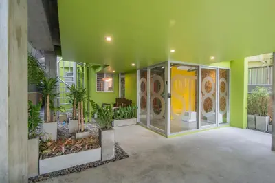 a room with green walls and plants in a building at ST88 Residence in Nonthaburi