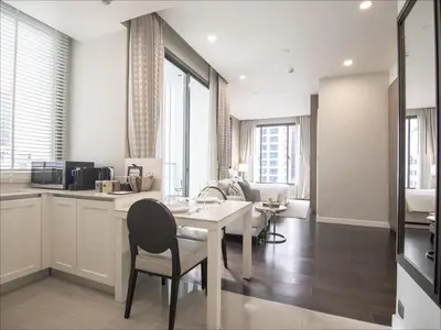 a kitchen and living room with a table and chairs at 137 Pillars Residences Bangkok in Bangkok