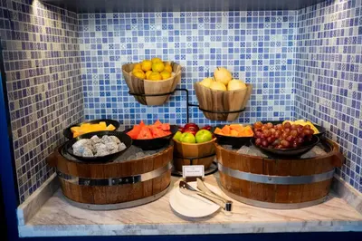 a display of fruits and vegetables in baskets on a wall at 137 Pillars Suites Bangkok in Bangkok