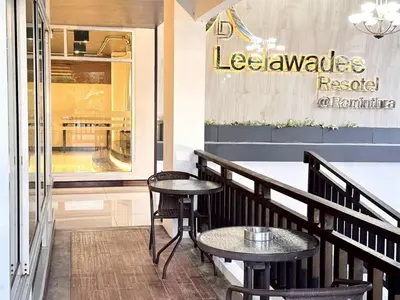 a restaurant with two tables and chairs in front of a store at ลีลาวดี รามอินทรา - Leelawadee Resotel Raminthra 23 in Bangkok