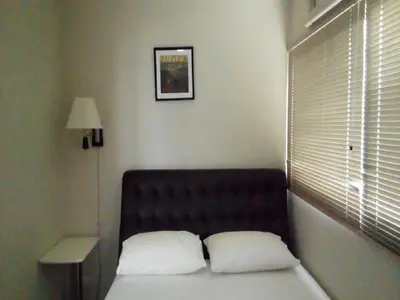 a bed with two pillows in a room with a window at IMPACT Challenger Muang Thong Thani Service Apartment in Bangkok