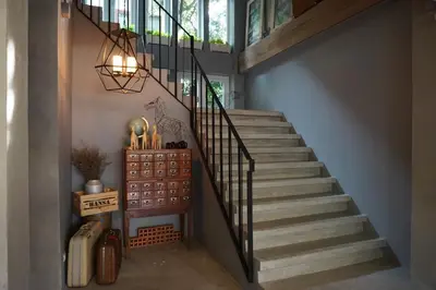 a staircase with a metal railing and a stair case at Hansa Bangkok House in Bangkok