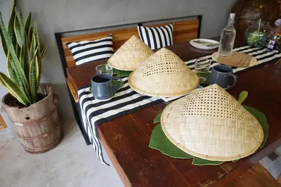 a wooden table with hats on top of it at Hansa Bangkok House in Bangkok