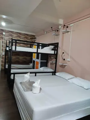 a room with three bunk beds in a room at Urban Hostel Bangkok in Bangkok