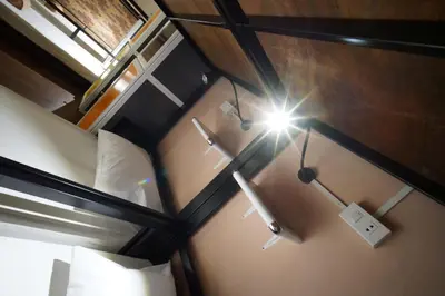 an overhead view of a room with a bed and a light at Urban Hostel Bangkok in Bangkok
