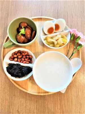 a plate of food with eggs and other bowls of food at Bangkok Loft Inn in Bangkok