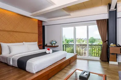 a bedroom with a large bed and a balcony at Dang Derm In The Park Khaosan in Bangkok