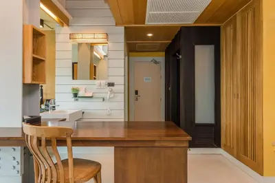 a bathroom with a wooden counter and a sink at Dang Derm In The Park Khaosan in Bangkok
