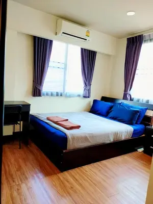a bedroom with a large bed with blue pillows at The Cube Sathorn Boutique Hotel เดอะ คิวบ์ สาทร บูติค โฮเทล Near BTS Surasak in Bangkok