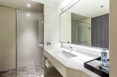 a bathroom with a sink and a mirror at Cross Vibe Bangkok Sukhumvit in Bangkok