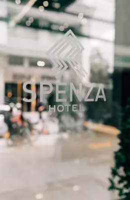 a logo for a hotel in front of a building at Spenza Hotel in Bangkok