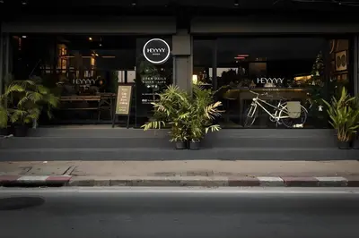 a restaurant with plants in front of a store at Heyyyy Bangkok in Bangkok