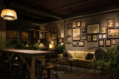 a living room with a couch and pictures on the wall at Heyyyy Bangkok in Bangkok