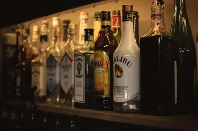 a shelf filled with lots of bottles of alcohol at Heyyyy Bangkok in Bangkok