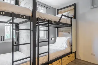 a couple of bunk beds in a small room at X9Hostel in Bangkok