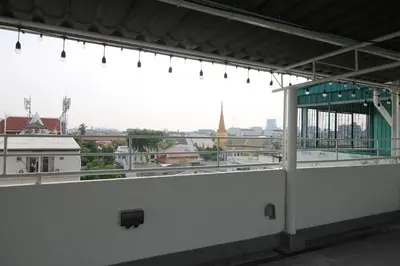 a balcony with a view of a city skyline at Baan Nampetch Hostel in Bangkok