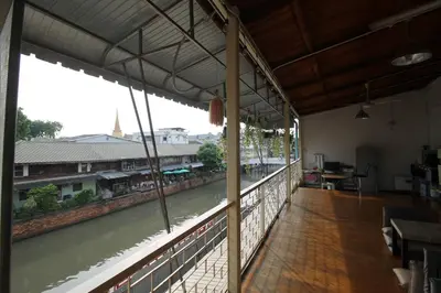 a view of a river from inside a building at Baan Nampetch Hostel in Bangkok