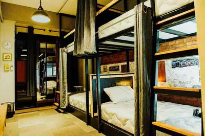 a bedroom with two bunk beds in a room at Popcorn House Ratchada in Bangkok